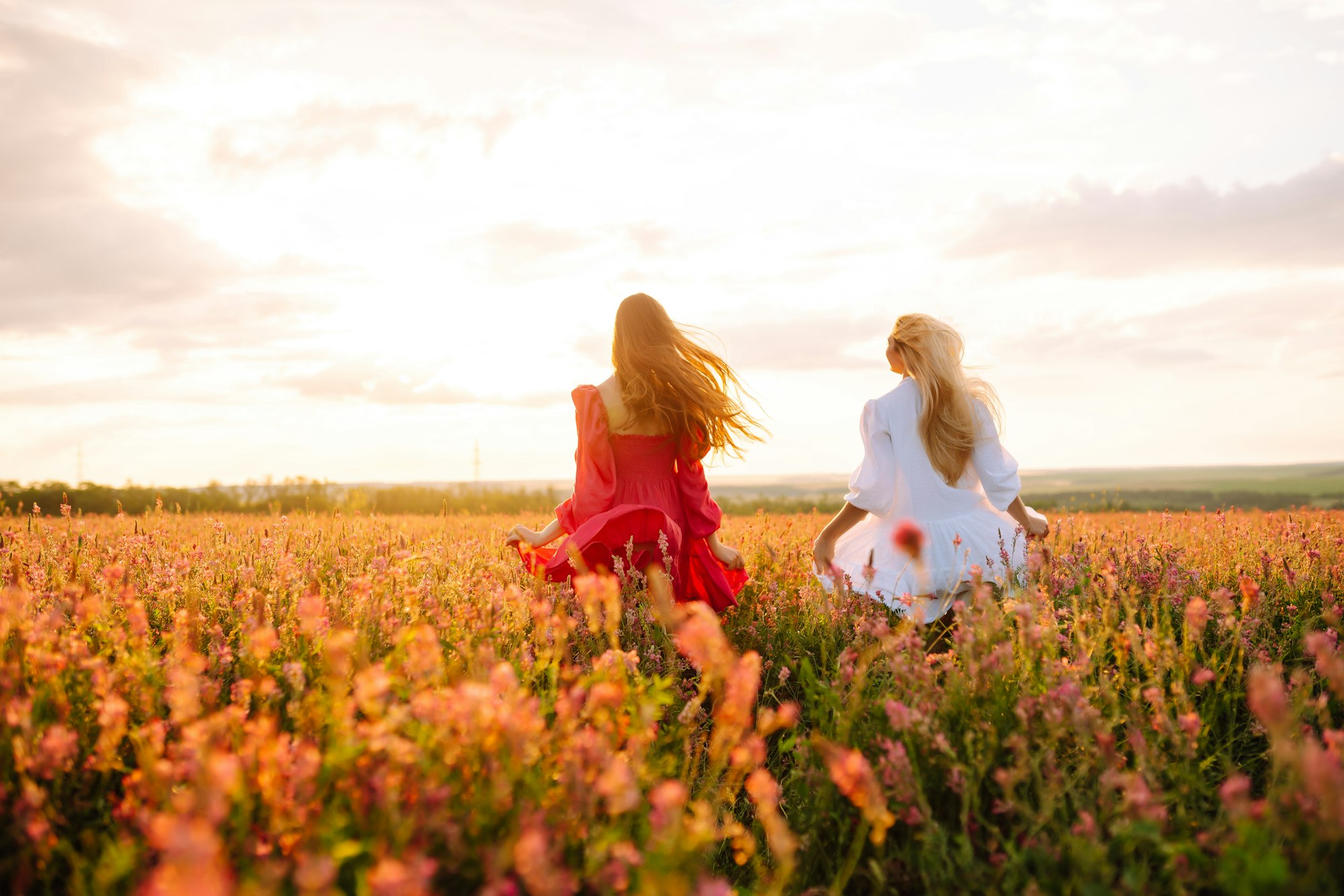 Two Beautiful woman in a field. Nature, fashion, vacation and lifestyle.